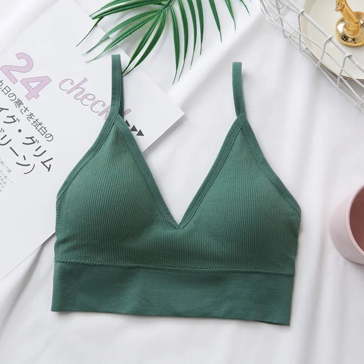 A dark green seamless U-back bralette with a V-neck and removable pads is displayed on a white background.
