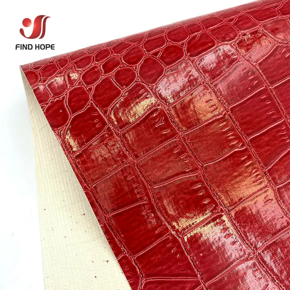 Close-up of red crocodile pattern faux leather fabric for crafting