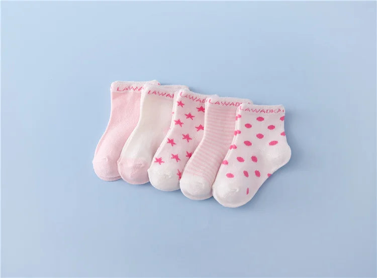 A set of pink and white striped cotton baby socks laid out on a light blue background.
