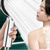 A woman is using a large high-pressure shower head with a rotatable panel to rinse her skin.