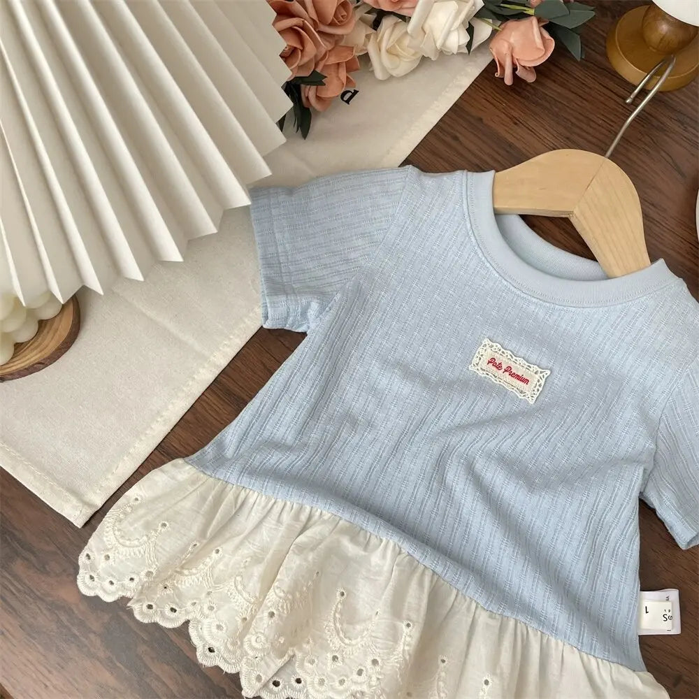 Light blue girls cotton short sleeve tee with a lace hem and wooden hanger