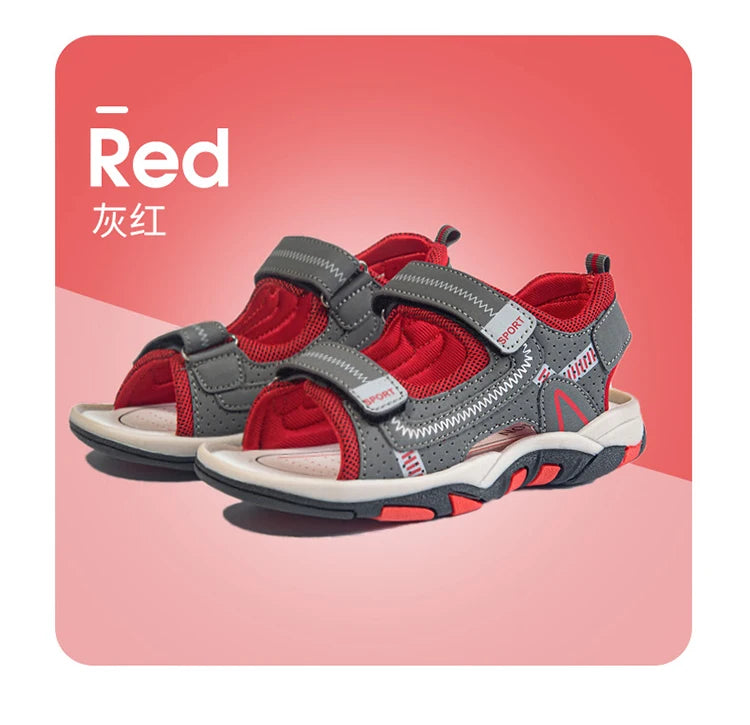 A pair of red and gray breathable summer sport sandals for boys shown against a pink background.