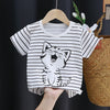 A white and black striped t-shirt featuring a cartoon cat graphic, displayed on a wooden hanger.