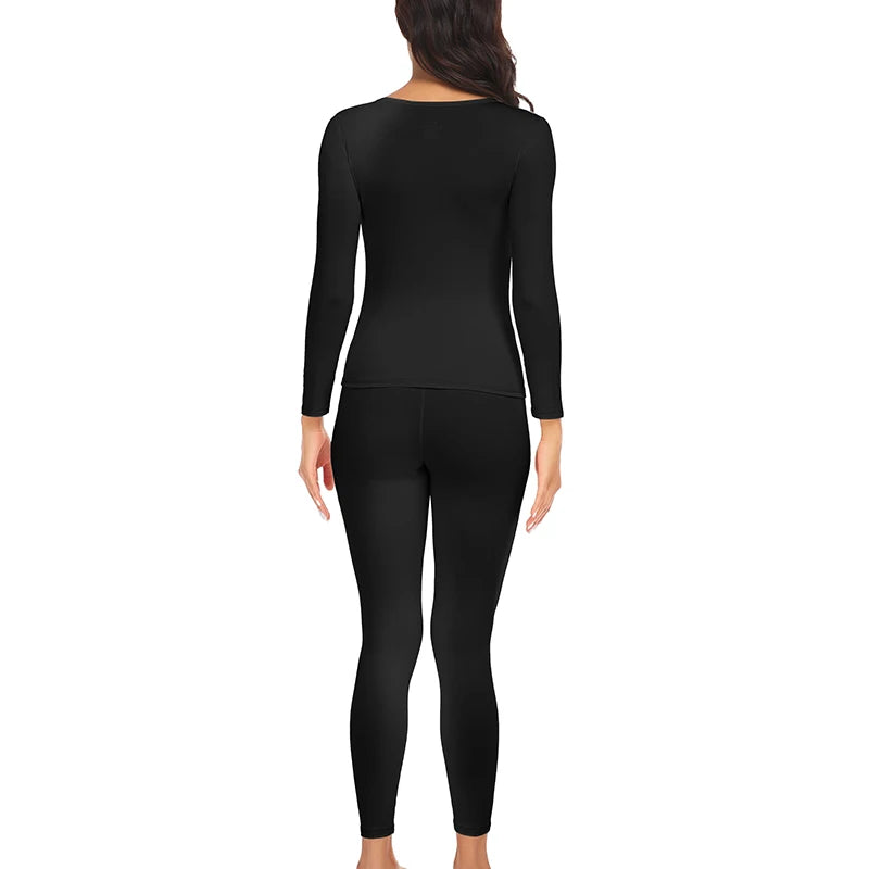 A woman wearing a black long-sleeved top and matching full-length leggings thermal underwear set.