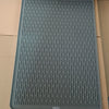 A gray silicone stove protector mat for induction and glass-top cooktops is shown in a cardboard box.