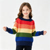 A young girl models a colorful rainbow striped knit sweater with long sleeves against a white background.