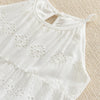 White cotton suspenders dress for a toddler girl with eyelet detailing