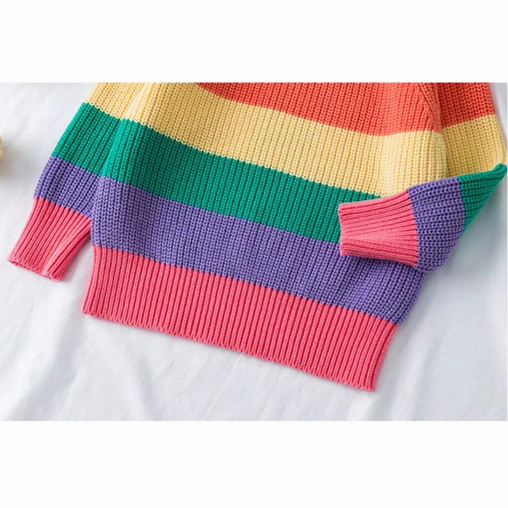 A colorful rainbow striped knit sweater featuring pink, purple, green, yellow, and orange hues.