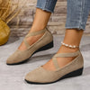 Ein Paar beige Damen-Riemchen-Keilabsatz-Loafer im römischen Retro-Stil, getragen an einem Fuß.