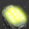 A transparent LED strobe light is illuminated with a bright yellow glow against a dark background, surrounded by water drople