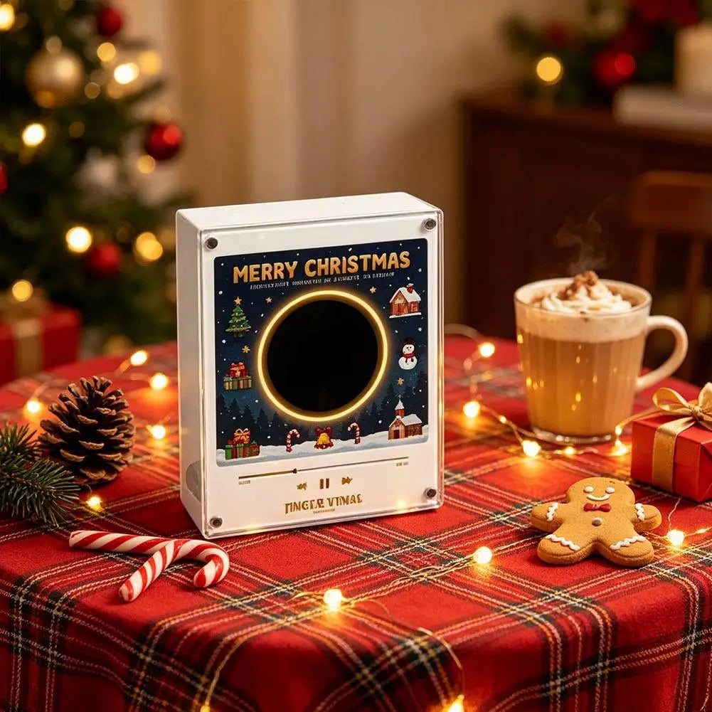 A white magnetic vinyl record player night light with interchangeable discs sits on a red plaid tablecloth surrounded by fest
