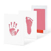 A white card with a pink handprint and footprint stamp, next to a pink card holder.