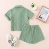 A light sage green toddler cotton linen summer shirt and shorts set displayed on a neutral background.