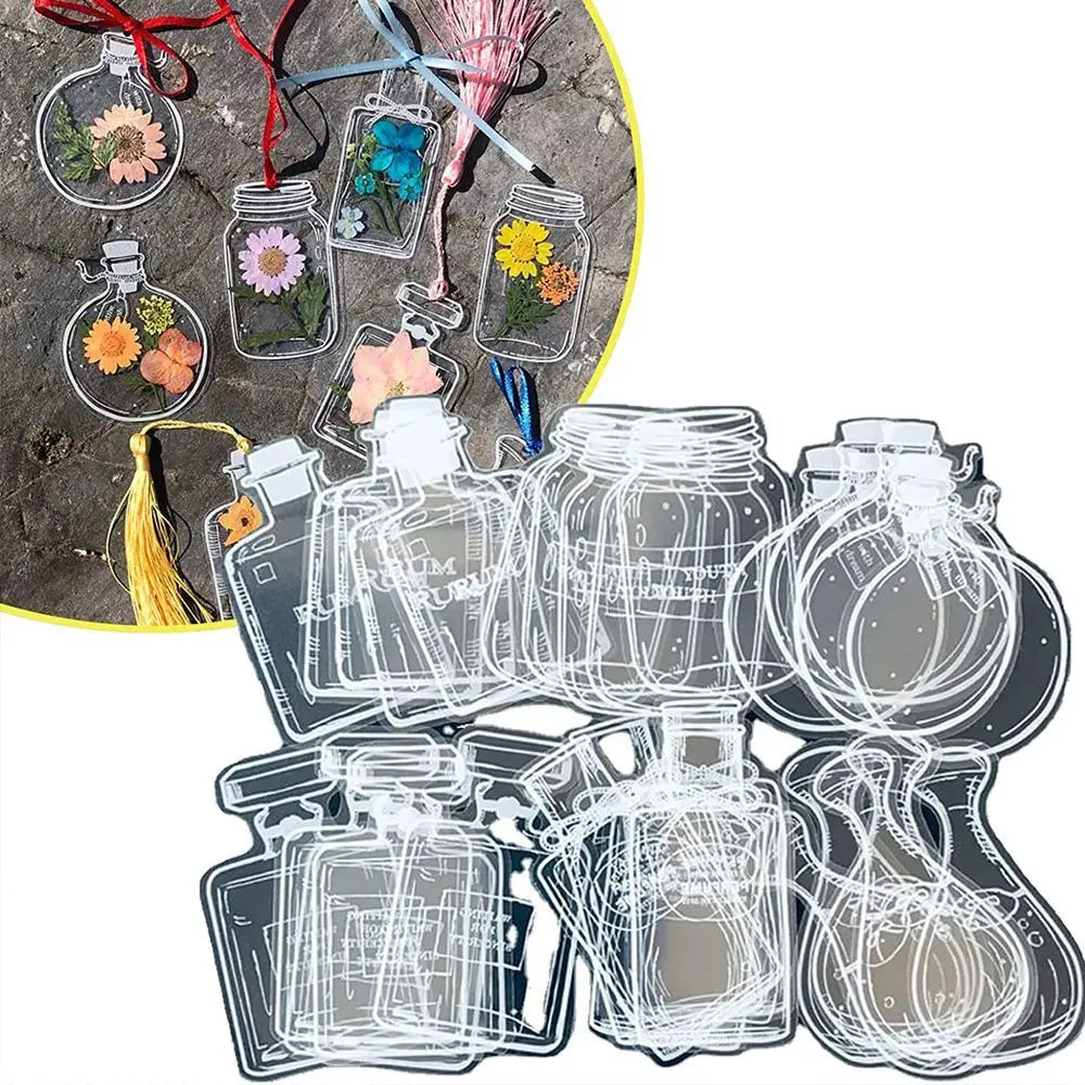 A collection of transparent glass jars filled with dried flowers and various decorative elements for bookmarks
