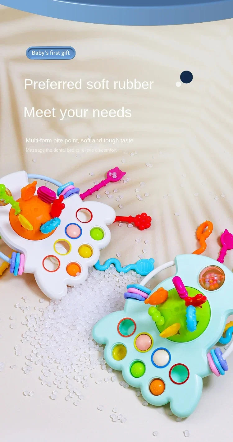 A colorful sensory pull string teething toy with multiple parts and rings is shown on a white surface.