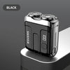 Una afeitadora eléctrica recargable mini USB negra con pantalla digital sobre una superficie gris claro.