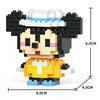 A Lego-style minifigure of a black and white animal with a light blue hat and yellow body parts.