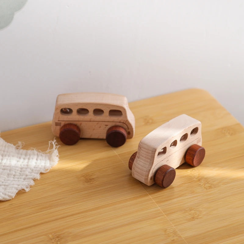 A light wood hand-pushed wooden cart toy for toddlers with round wheels resting on a wooden surface.