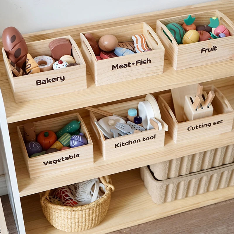 A wooden pretend play food cutting set with various foods like meat fish fruit and vegetables stored in individual compartmen