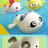 Three cute bath toys featuring a duck and a penguin floating in blue water.