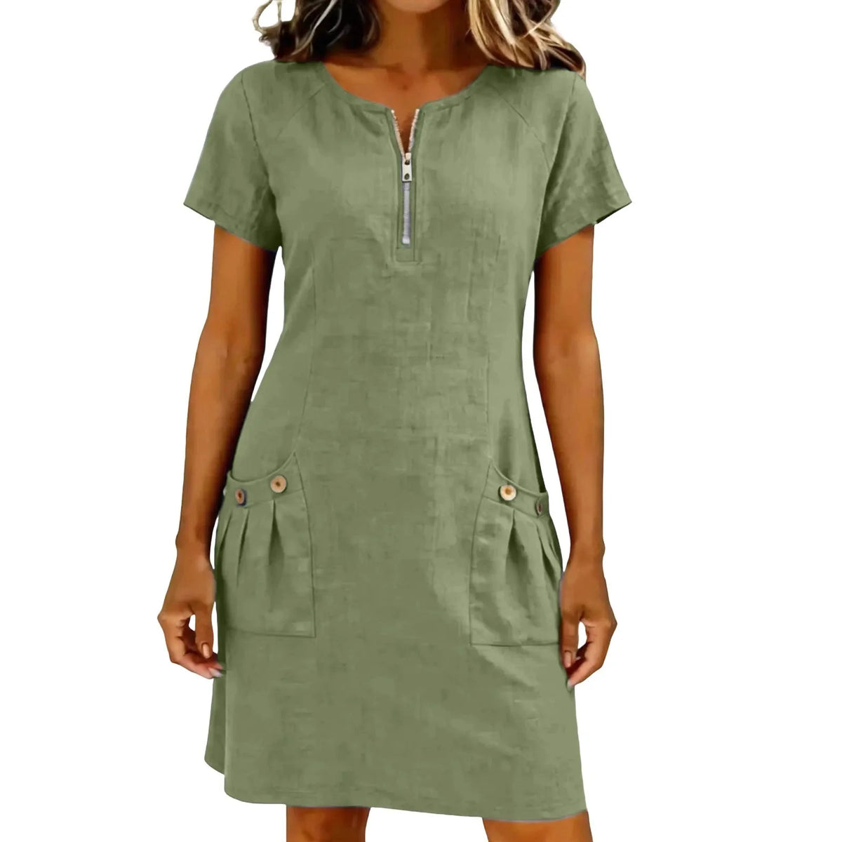 A woman wearing an olive green lightweight cotton-linen short sleeve dress with a zippered collar and front pockets.