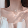 A close-up of an elegant double-layer butterfly pendant necklace worn around the neck.