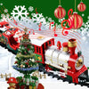 A red and white musical Christmas train with Santa, colorful lights, and a decorated Christmas tree in a snowy setting.