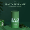 A tube of green beauty skin mask with a light green cap and label is displayed on a green surface.