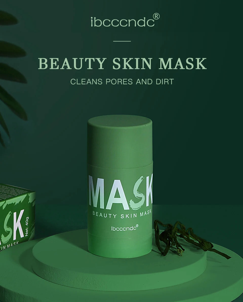 A tube of green beauty skin mask with a light green cap and label is displayed on a green surface.
