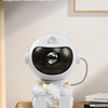 A white astronaut design desk ornament featuring a spherical visor and detailed suit, displayed on a wooden surface.