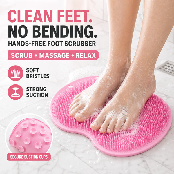 A person's feet are being scrubbed with a pink silicone hands-free foot scrubber on a white surface.