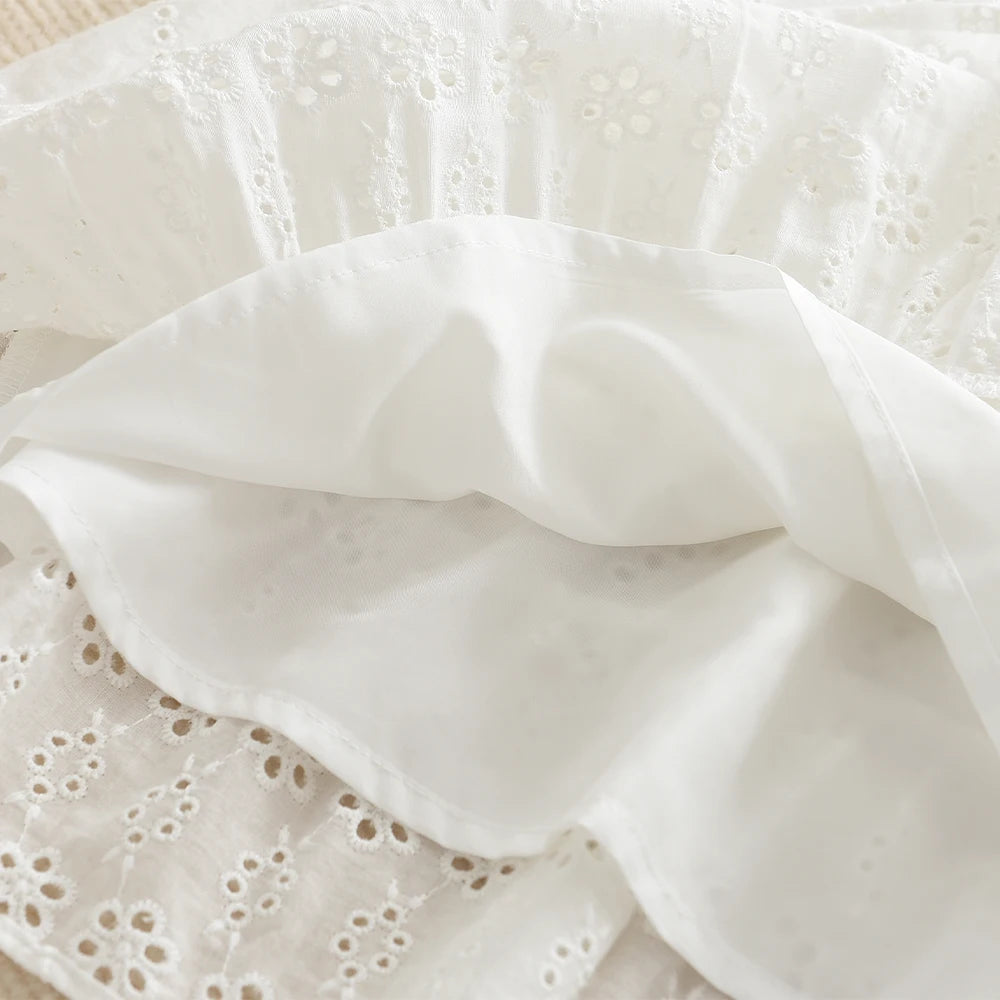 White cotton dress with delicate lace and ruffled fabric for a toddler girl