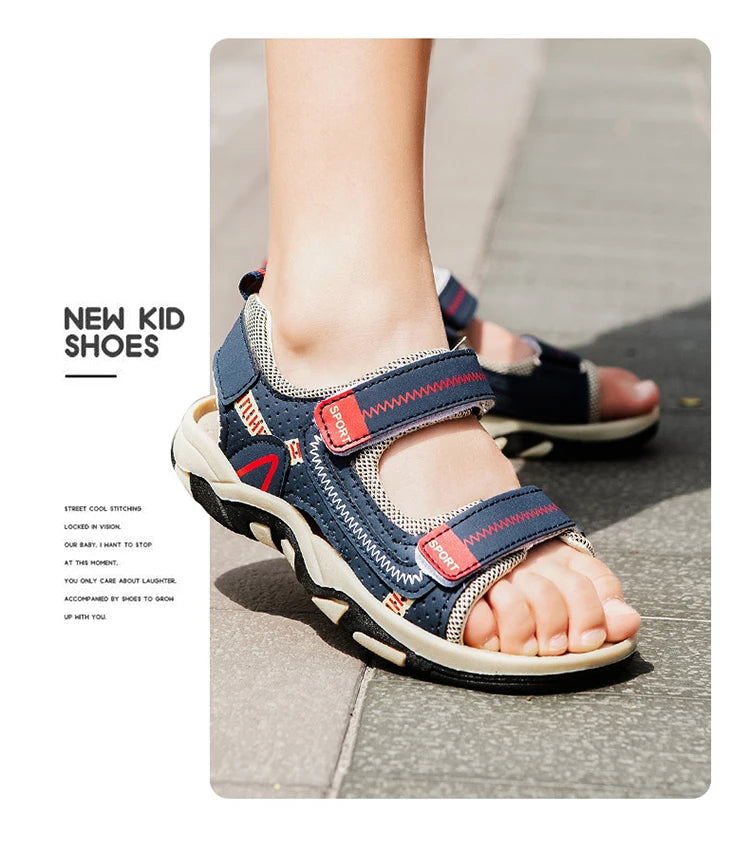 A close-up of new kid shoes, blue and red sport sandals with adjustable straps, worn on a foot.