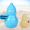 A bright blue duck-shaped rice mold resting on sand, with a yellow molded shape nearby.