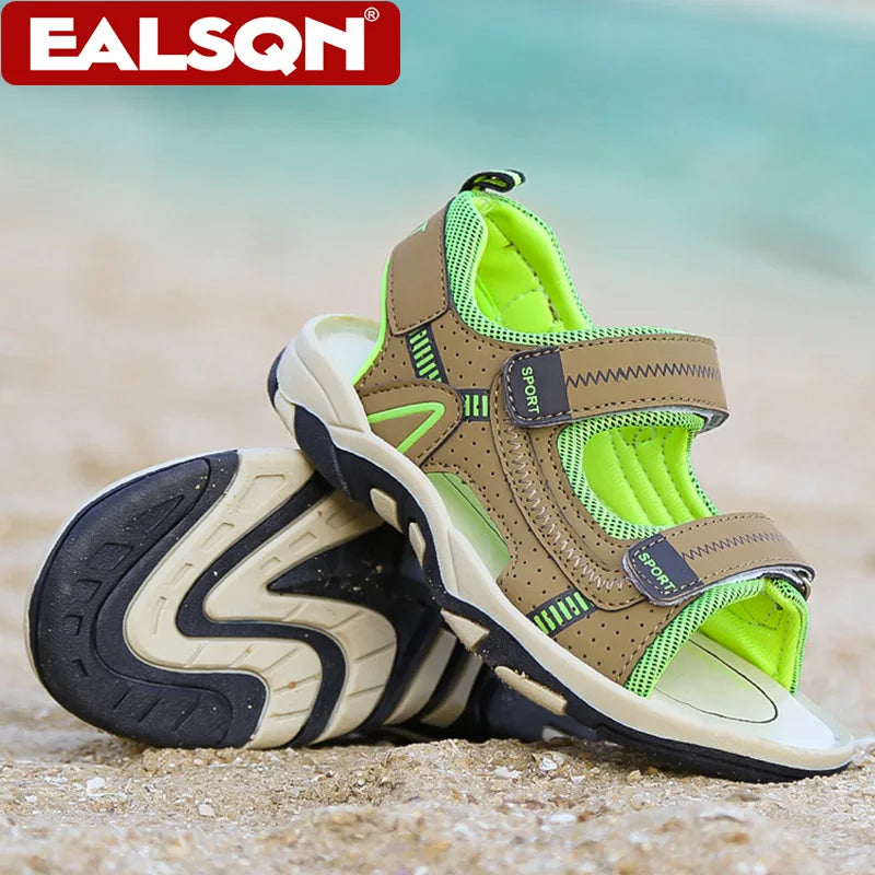 A pair of beige and lime green breathable summer sport sandals resting on light sand.