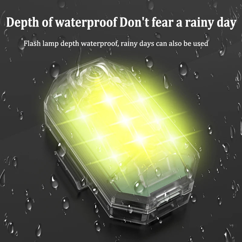 A transparent waterproof flashlight with a bright yellow LED light shining through raindrops.