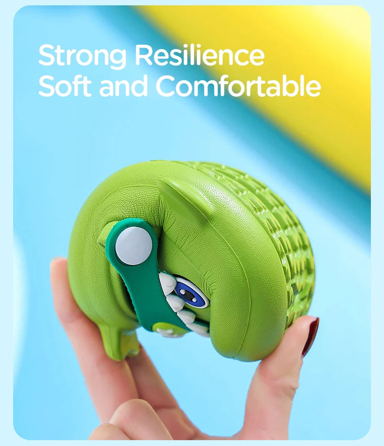 A hand holds a lime green kids shark clog sandal, highlighting its soft and comfortable design.
