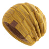 A yellow knit beanie with a brown faux fur trim and a leather patch detail.