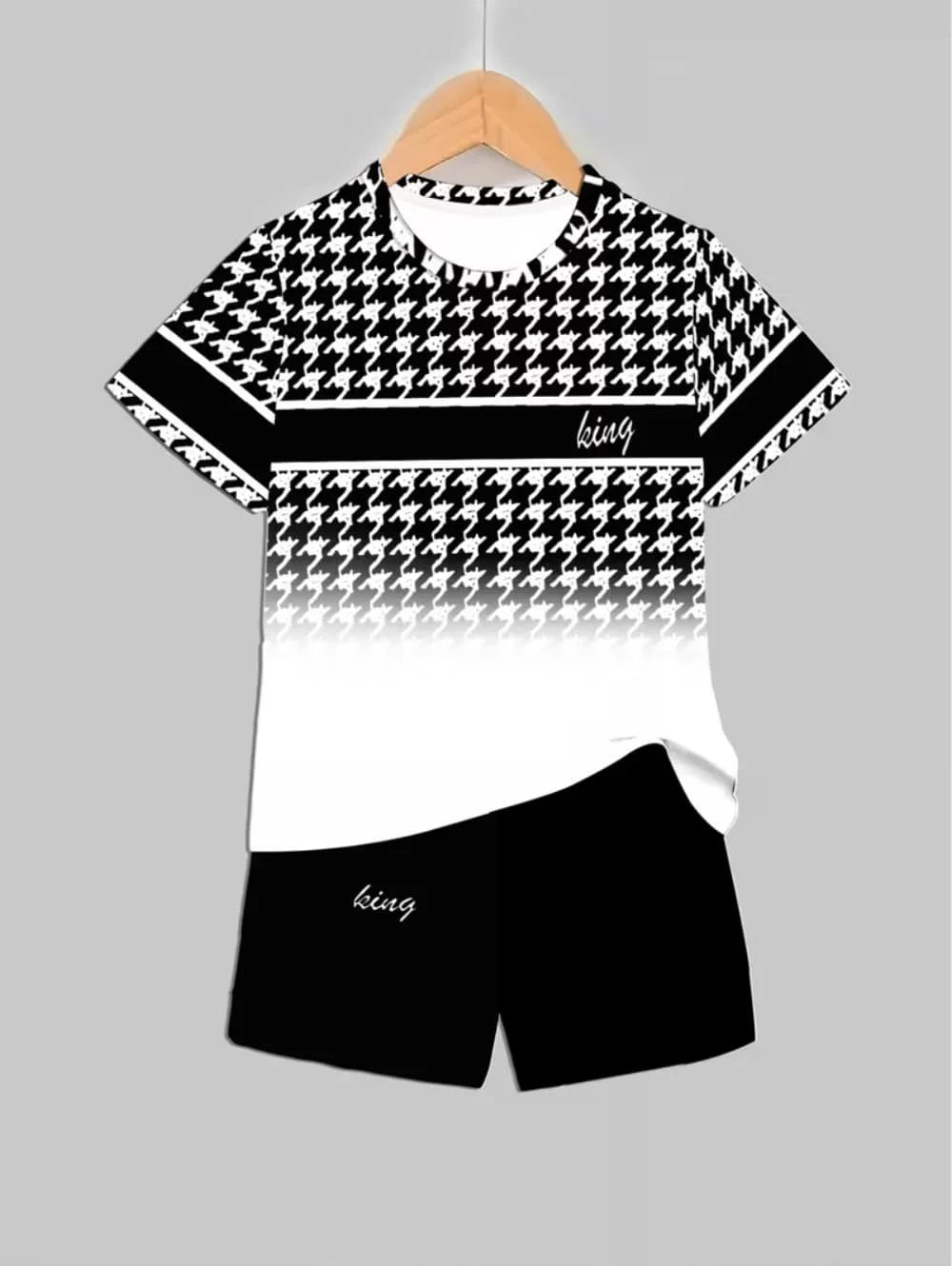 A black and white patterned short sleeve t-shirt and matching shorts set displayed on a hanger.