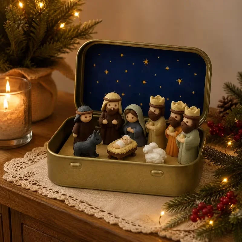 A classic nativity scene in a gold-colored metal tin box featuring figures of Mary, Joseph, and the baby Jesus under a starry