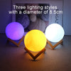 Three lighting styles of 8.5cm diameter moon LED night lights glowing purple, yellow, and white.