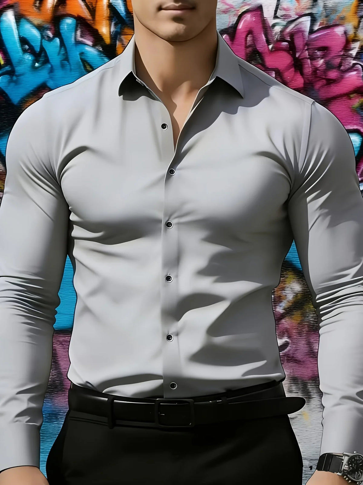 A male model wearing a gray long-sleeve formal shirt and black trousers against a colorful graffiti background.