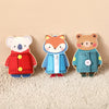 Three wooden Montessori busy board figures of animals dressed in clothing