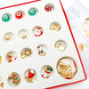 A white advent calendar box filled with small charm bracelets and jewelry for a 24-day Christmas countdown.