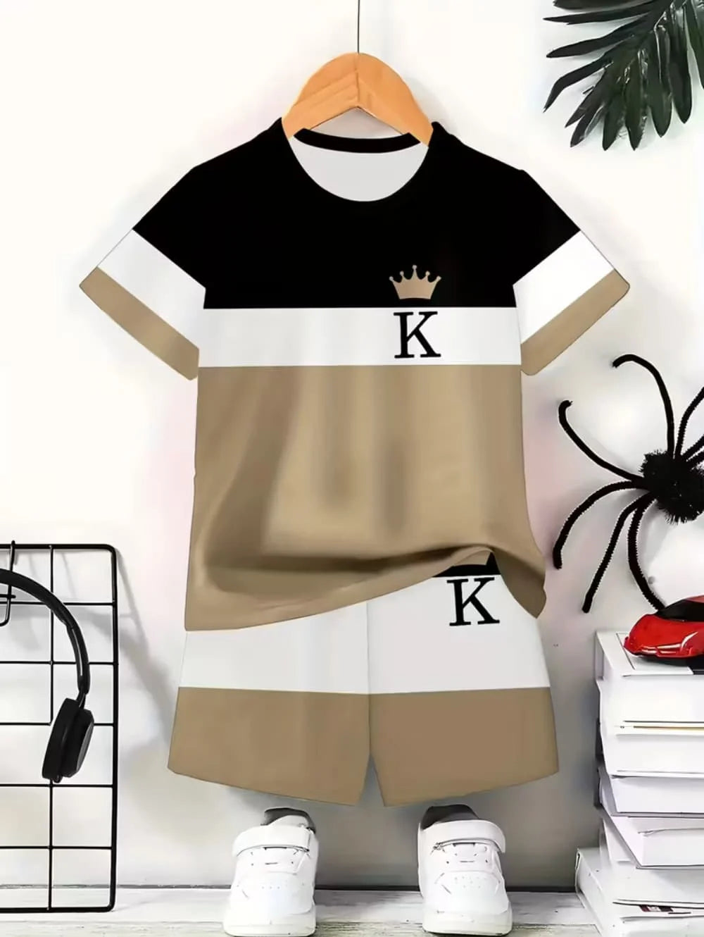 A beige and black colorblock short sleeve t-shirt and shorts set displayed on a hanger.