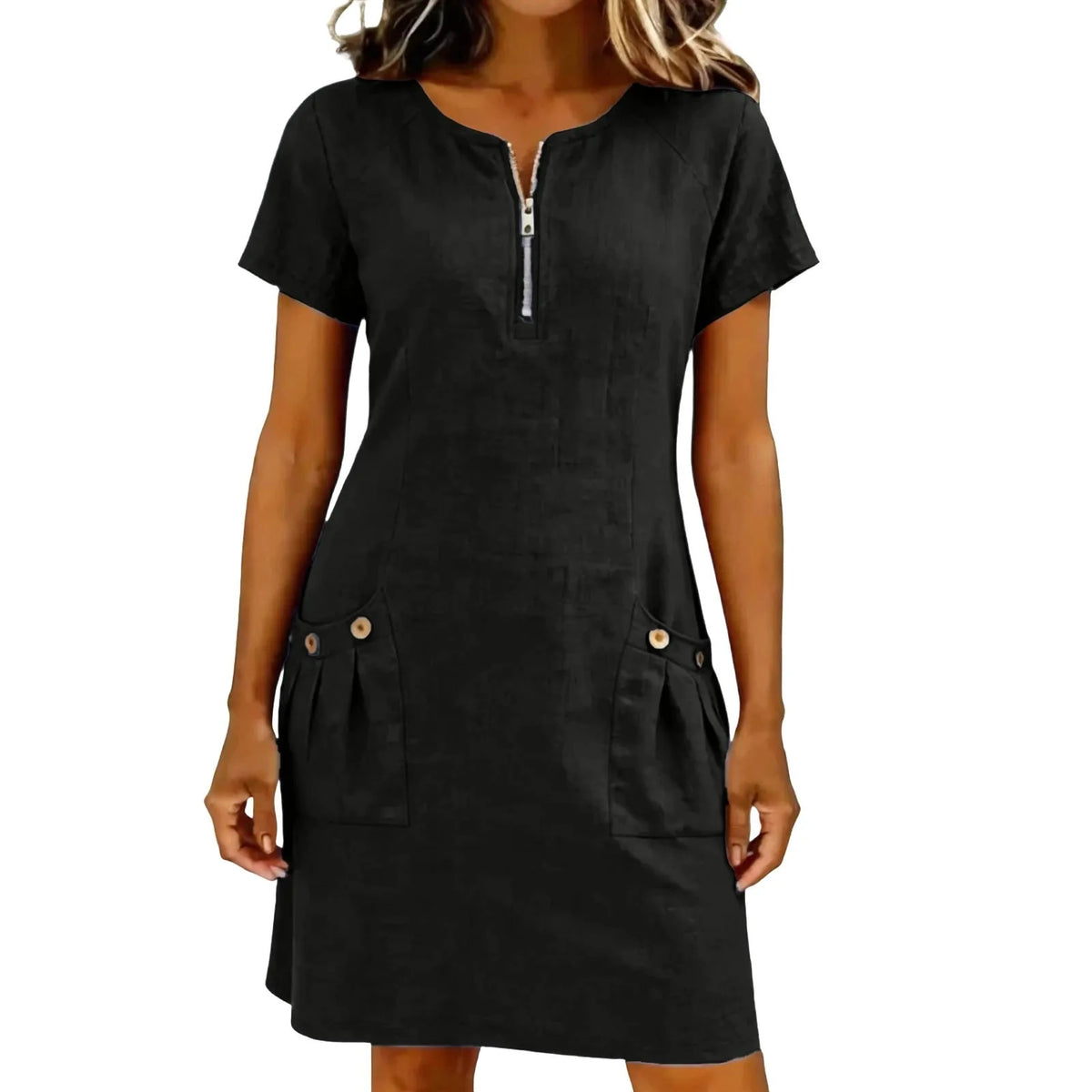A woman wearing a black lightweight cotton-linen short sleeve dress with a collar and front zipper and side pockets.