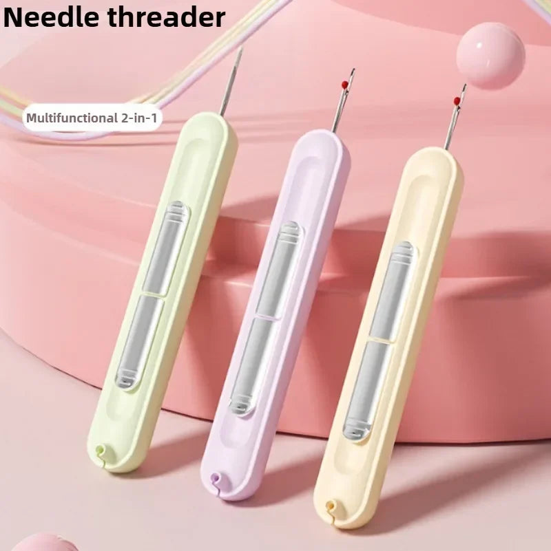 A set of two multifunctional needle threaders in light green and purple plastic are displayed on a pink background.