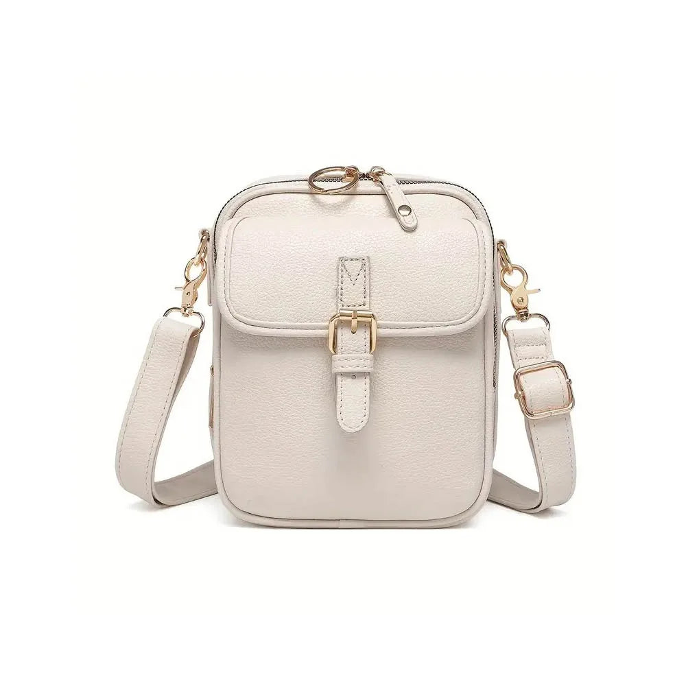 A light beige vintage vegan leather messenger bag with a gold-tone adjustable strap.