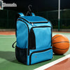 A bright blue sports backpack resting on a green court surface next to a basketball.