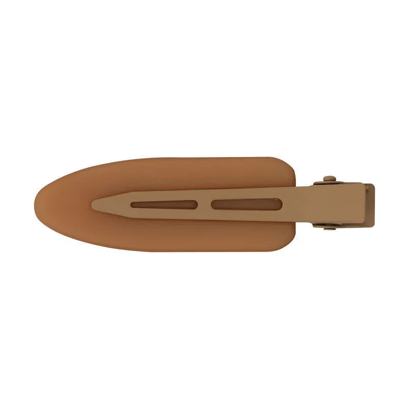 A pair of matte resin side hair clips in a tan or nude color.